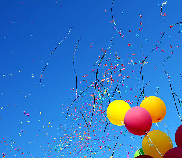 istock Pink and yellow balloons and confetti 450845331