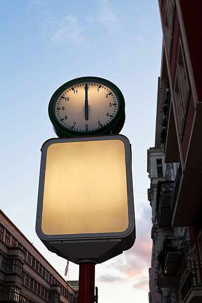 istock street clock and blank advertising billboard 450845737