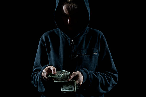 Thief Counting the Cash stock photo