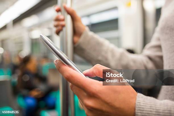 Woman Using Her Cell Phone In Subway Stock Photo - Download Image Now - Adult, Adults Only, Capital Cities