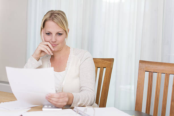 istock A young woman sitting at the table reading a letter 450849903