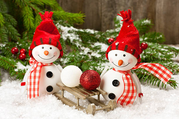 istock two smiling snowmen friends in the snow 450852571