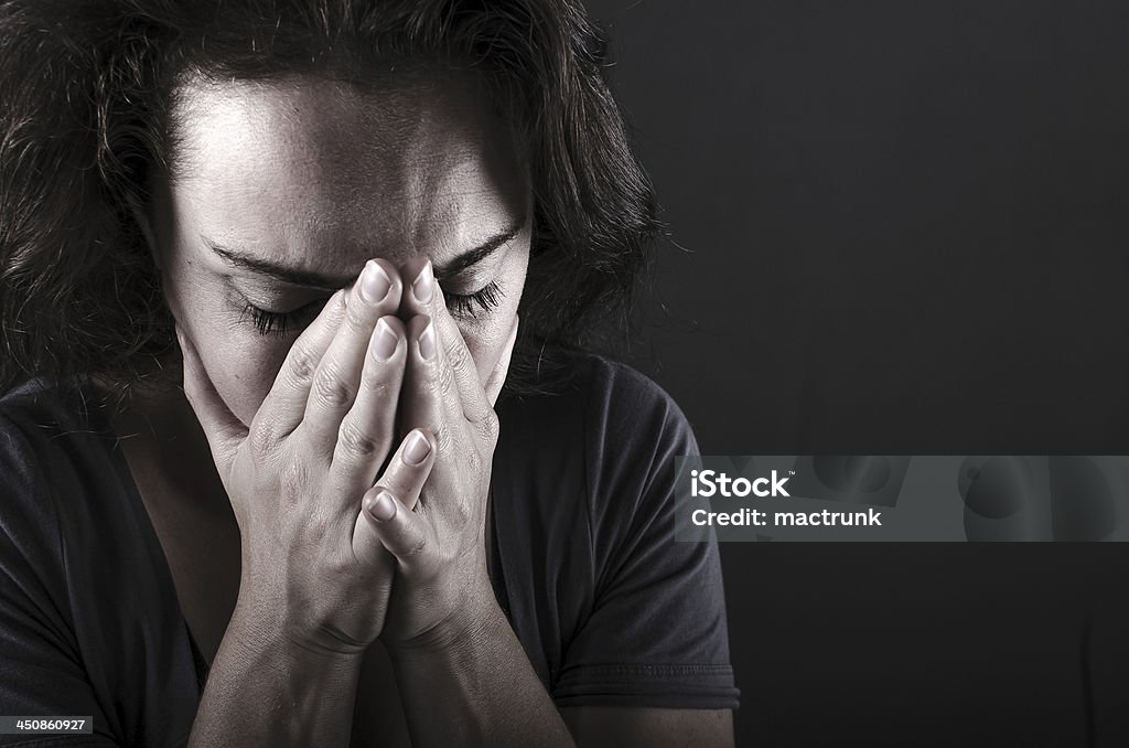 Depressed woman Depressed woman on black background Adult Stock Photo