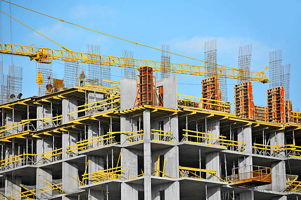 Crane and construction site Crane and building construction site against blue sky construction skyscraper machine industry stock pictures, royalty-free photos & images