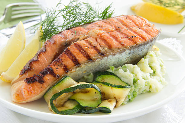 istock Salmon fried on a grill with zucchini. 450867497