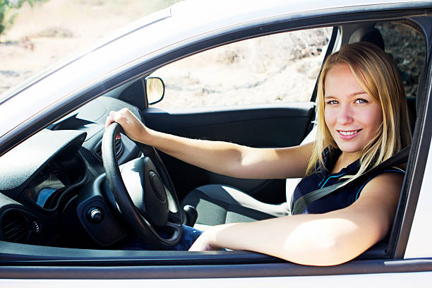 istock Beautiful blond woman in car 450874587