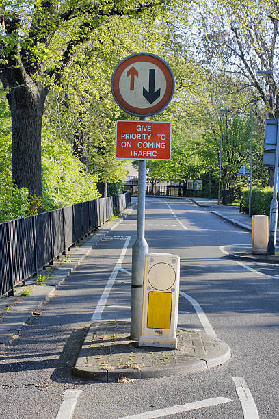 istock Road sign give way to oncoming traffic 450876997