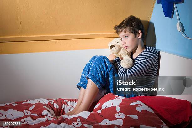 Afraid And Depressed Young Boy Stock Photo - Download Image Now - Bed - Furniture, Child, Child Abuse