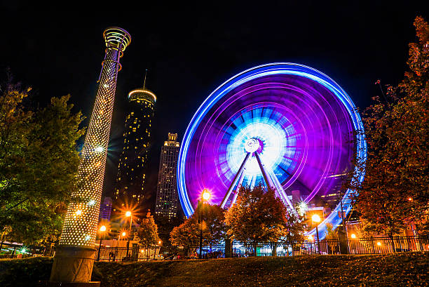Atlanta downtown Ferris Wheel in motion lit up at night