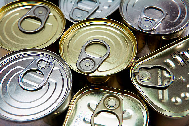 Tins of different sizes and opening Tins of different sizes and opening canned food stock pictures, royalty-free photos & images
