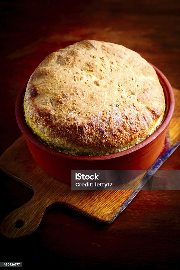 Homemade bread Homemade bread in ceramic pot on wood table Baked Stock Photo