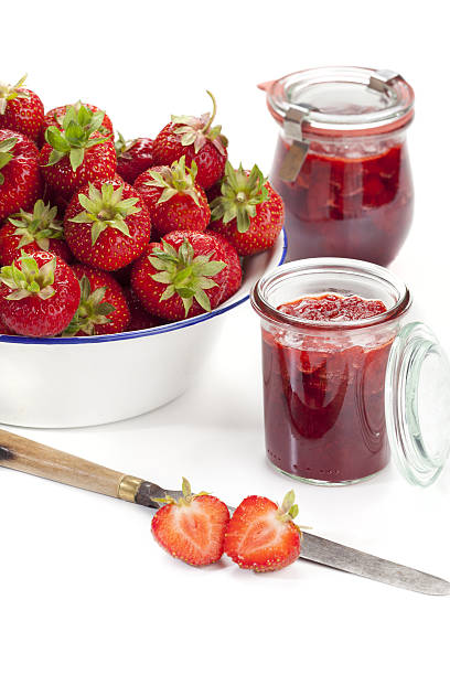 istock Fresh strawberries and jam jars 450935395