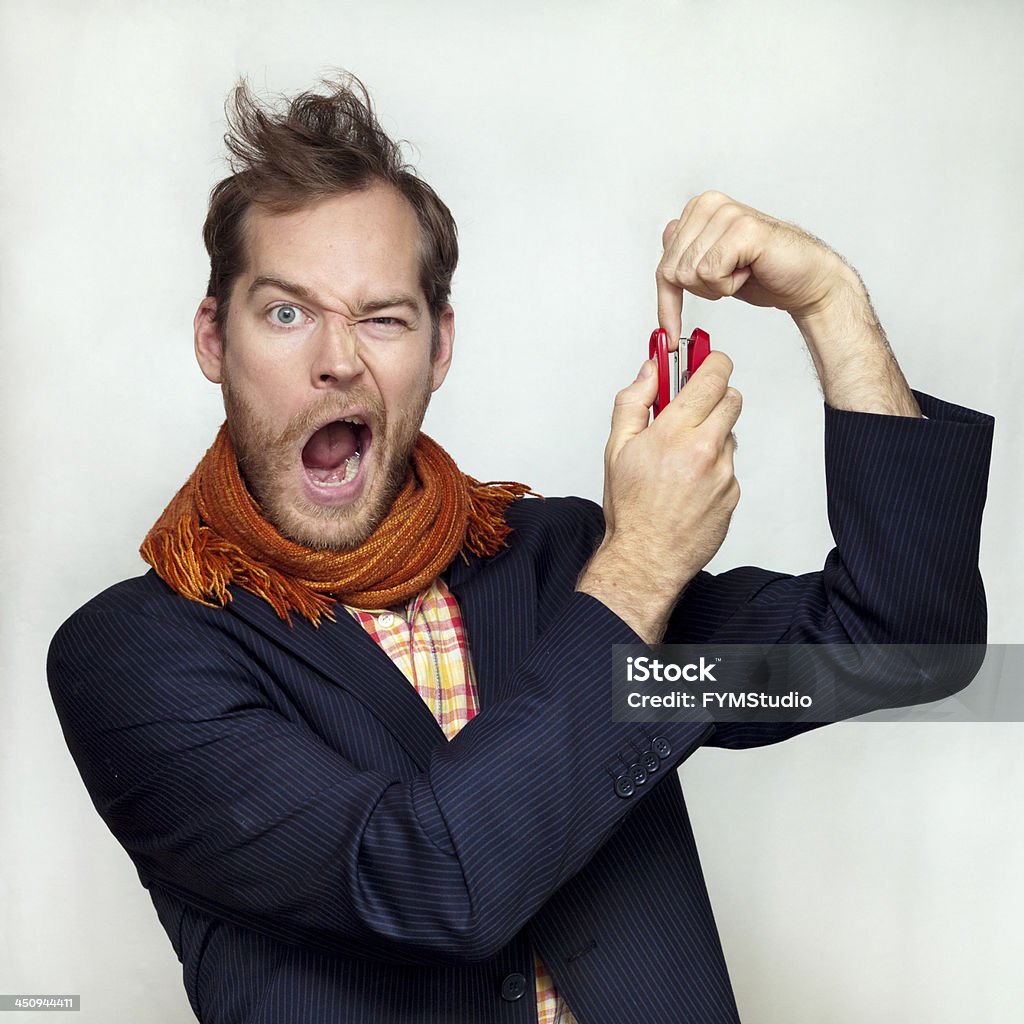 Man steepled his finger A Man in a suit and orange scarf is screaming in pain, steepled his finger through, isolated on gray Stapler Stock Photo