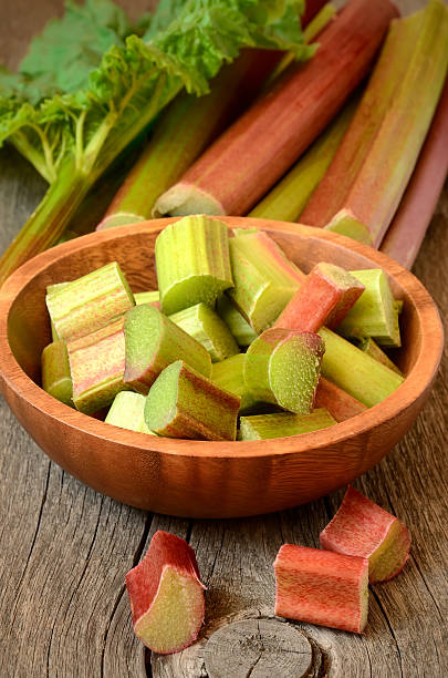 istock Fresh rhubarb on wooden garden table 450944417
