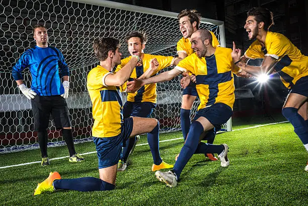 Photo of Football match in stadium: Scorer's celebration