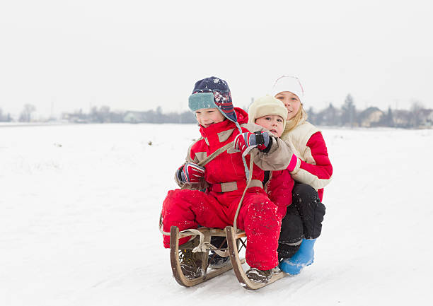 istock Children makes winter fun with sledge outdoor 450953937