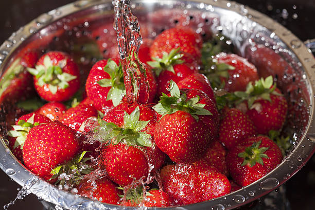 istock Red ripe strawberries in a stainless steel colander 450954855