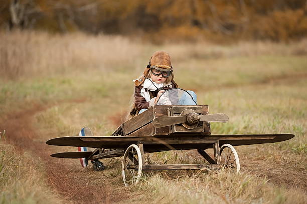 istock Young female piloting a homemade plane in a field 450955853