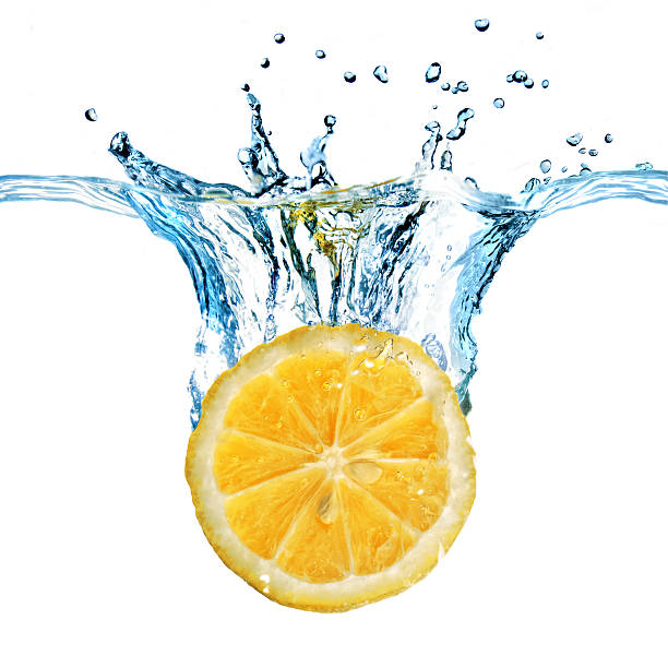 istock Fresh lemon dropped into water with splash isolated on white 450956957