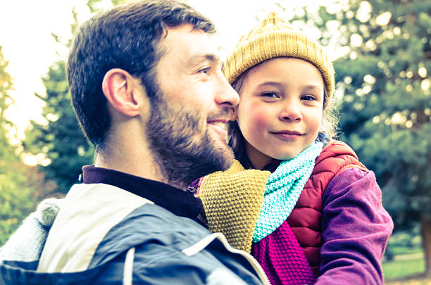 istock Father Holding Daughter in a Park 450968615