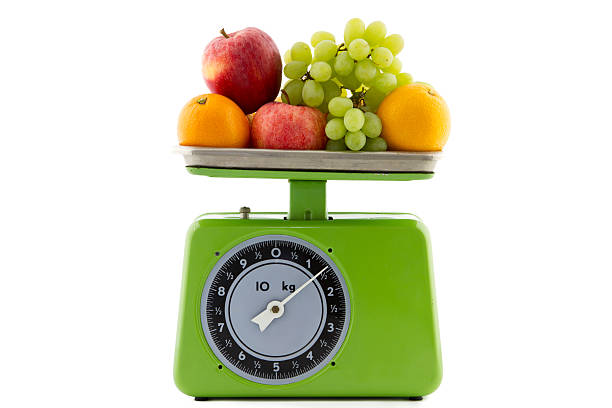 vintage kitchen scale with fruit green vintage kitchen scale with oranges, apples and white grapes kitchen scale stock pictures, royalty-free photos & images