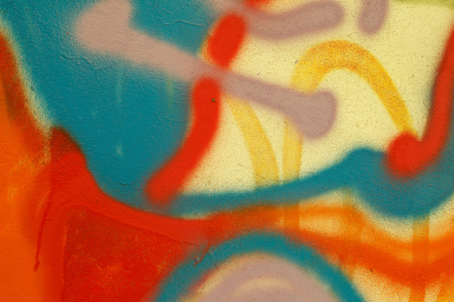 Part of a bright multi-colored wall graffiti. Youth art culture.