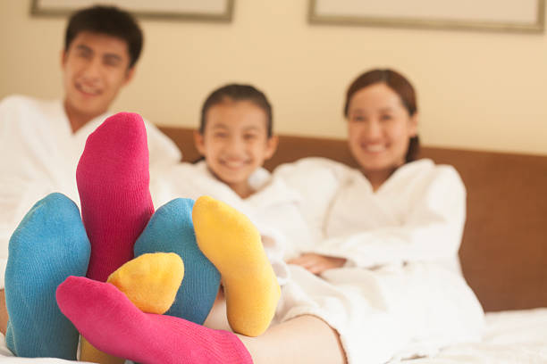 Family with Multi Colored Socks Family with Multi Colored Socks bed human foot couple two parent family stock pictures, royalty-free photos & images