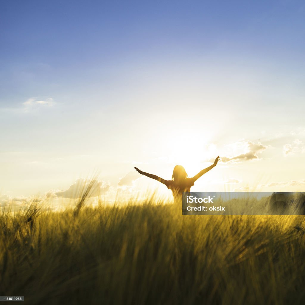 Girl on sunset Teenage girl enjoy with sunshine in wheat field Adult Stock Photo