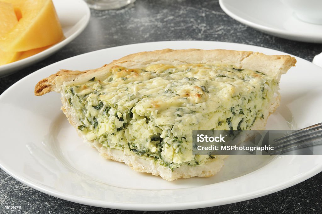 Spinach quiche with cantaloupe Quiche Florentine with sliced cantaloupe Egg - Food Stock Photo