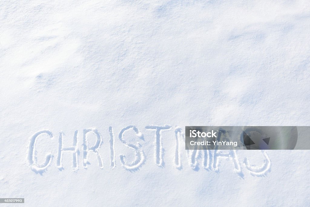 CHRISTMAS Word Written on White Winter Snow with Copy Space The word "Christmas" etched by hand into a smooth snowdrift on a sunny winter day. Brightly Lit Stock Photo