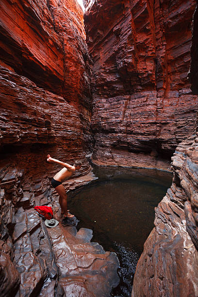 istock Man swimming water hole deep in gorge 451043197