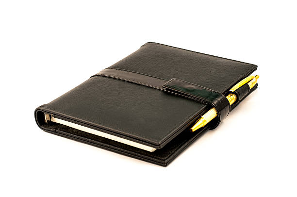 negro libro de notas con bolígrafo - pen ballpoint pen isolated registration fotografías e imágenes de stock