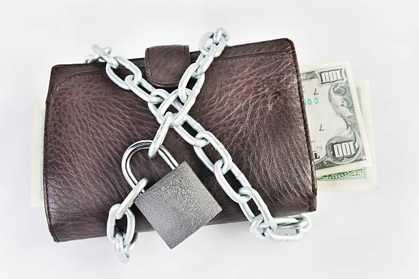 istock Wallet full of money is chained with a padlock 451050361