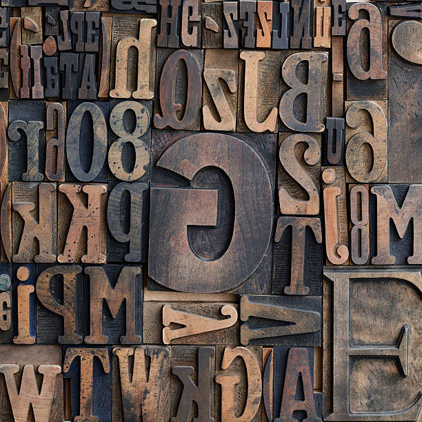 Wooden printers typeface letters Jumbled arrangement of different sized wooden printers typeface letters of the alphabet forming a background pattern printing plate photos stock pictures, royalty-free photos & images