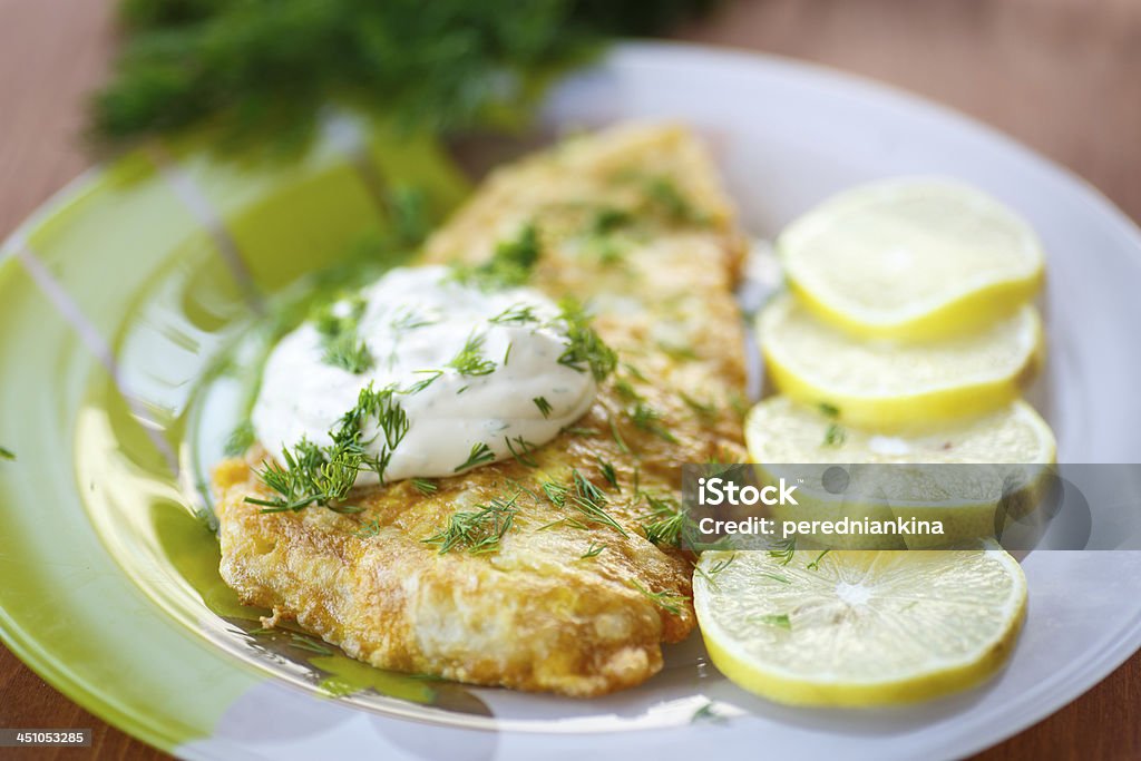 fried fish fried fish with sauce and lemon on a plate Batter - Food Stock Photo