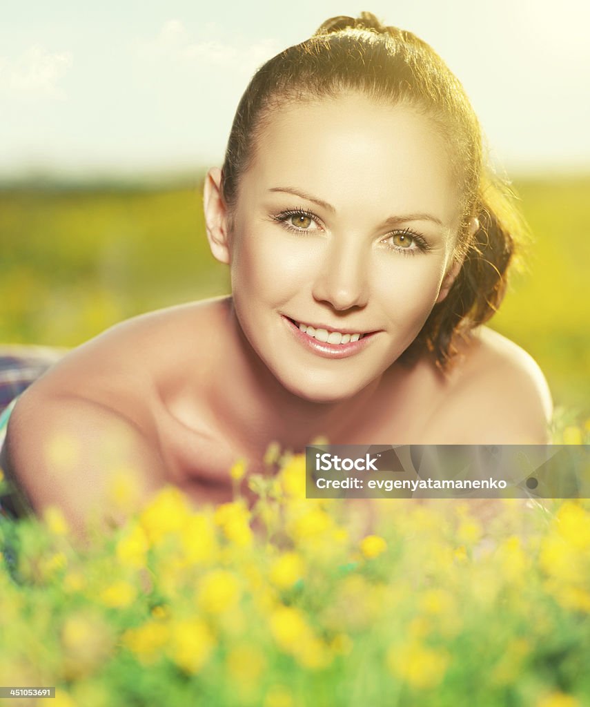young happy woman on nature in the summer young happy woman on nature in the summer outdoors Adult Stock Photo