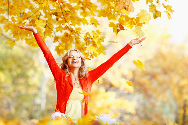 istock Happy woman in autumn park 451053749