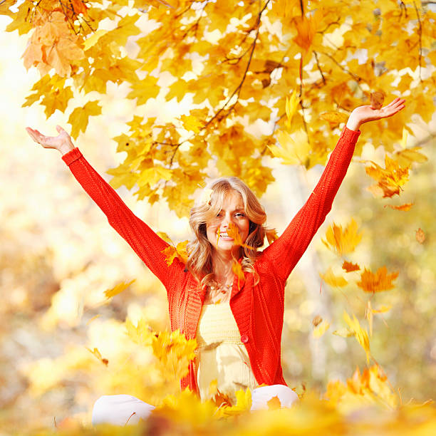 istock Happy woman in autumn park 451053781