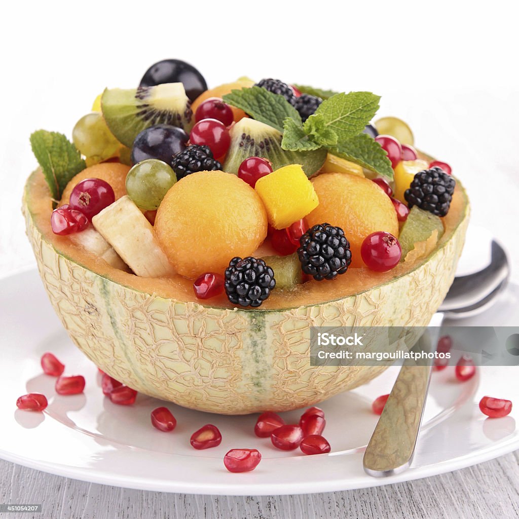 fruit salad fruit salad in melon bowl Banana Stock Photo