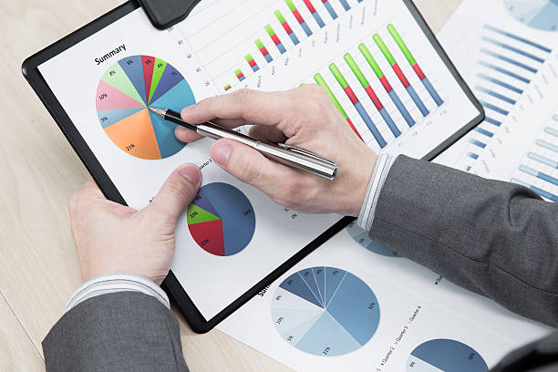 istock man hand with business report 451054993