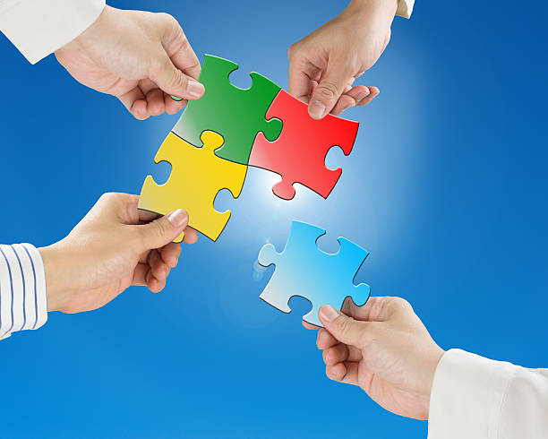 istock Hands hold puzzles with clear blue sky and sun light 451055055