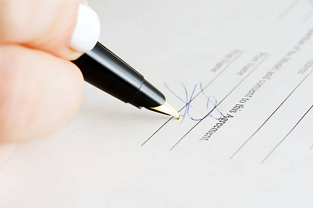 istock Female hand signing contract 451055499