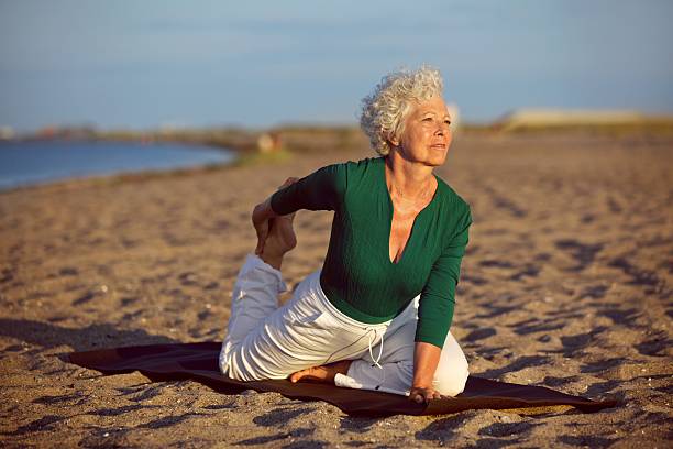 istock Yoga exercise on the beach 451055519
