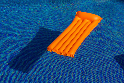 Orange Lilo in Swimming Pool