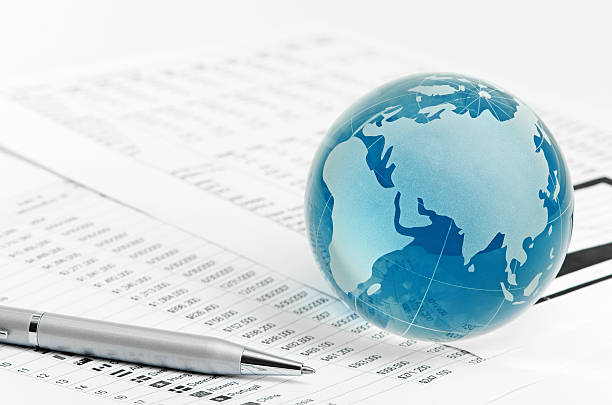 istock Glass globe and pen on finance 451065743