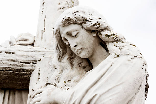 A beautiful cemetery sculpture of Jesus Christ lifting His eyes to Heaven in prayer. Copy space provided.