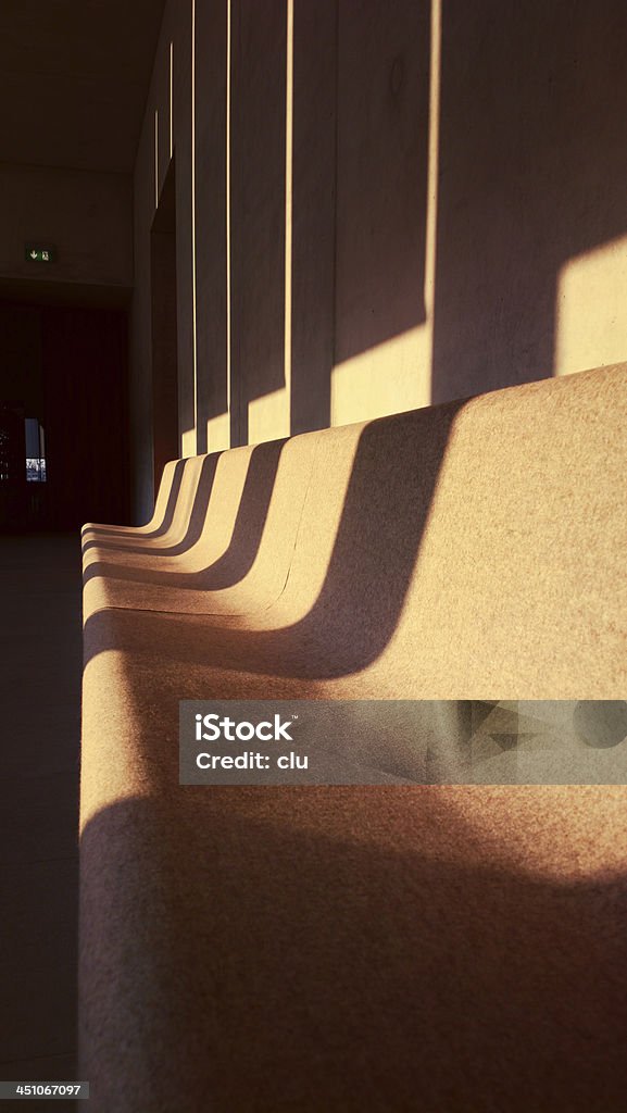 Endless felt bench in the last sunrays Indoor shot vertical Bench Stock Photo