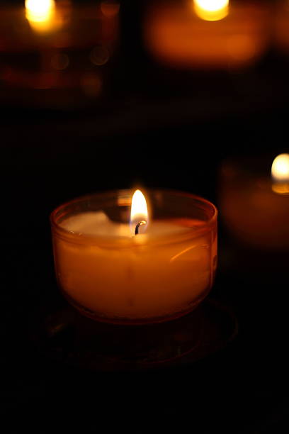 istock burning candles in church 451067101