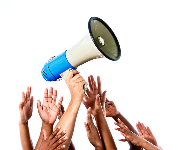 istock I want to speak! Many hands reaching for megaphone 451070791