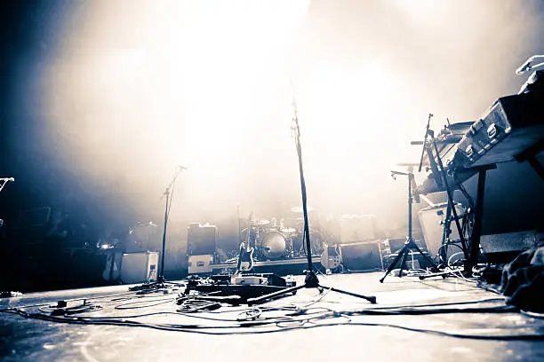 Photo of Empty stage littered with musical accessories
